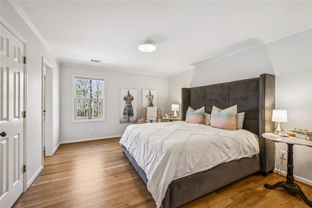 4575 Jett Road Atlanta, GA 30327 - Photo 22 of 42 a bedroom with bed and wooden floor