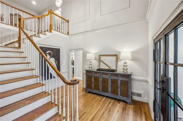 a view of a hallway with wooden floor and staircase