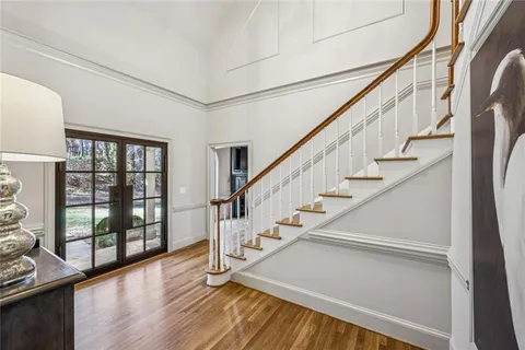 a view of entryway and hall with wooden floor