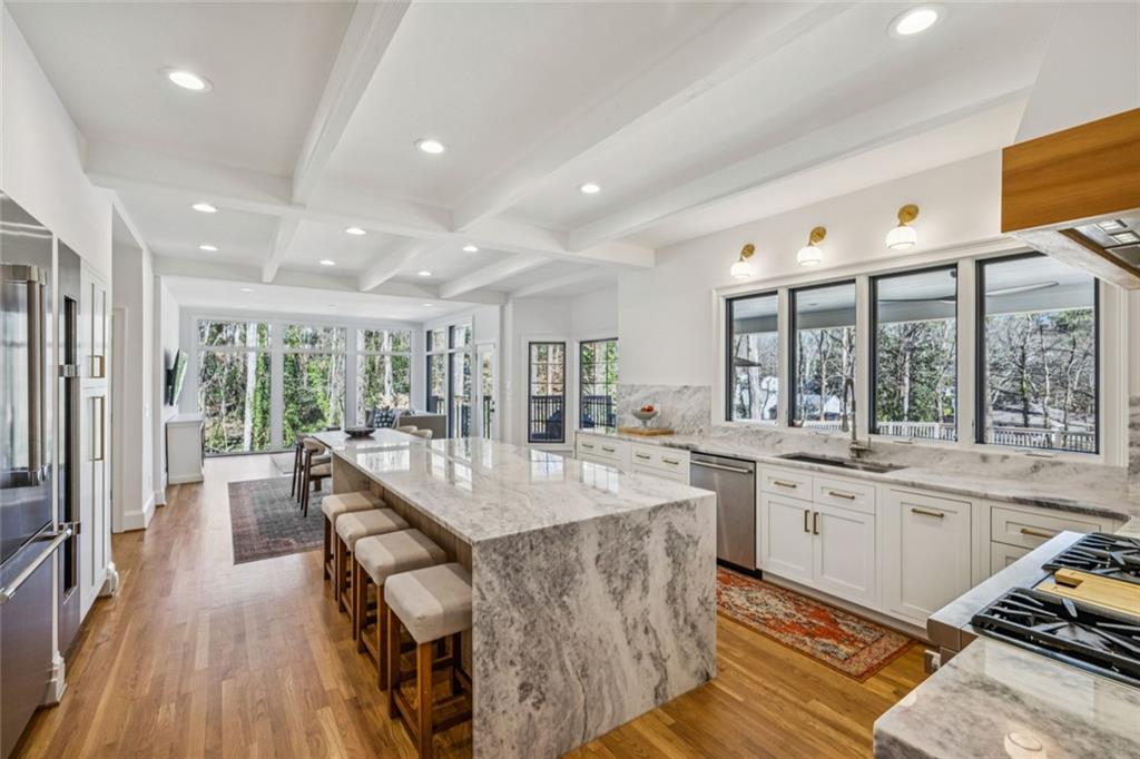4575 Jett Road Atlanta, GA 30327 - Photo 8 of 42 a dining hall with stainless steel appliances granite countertop dining table chairs and wooden floor
