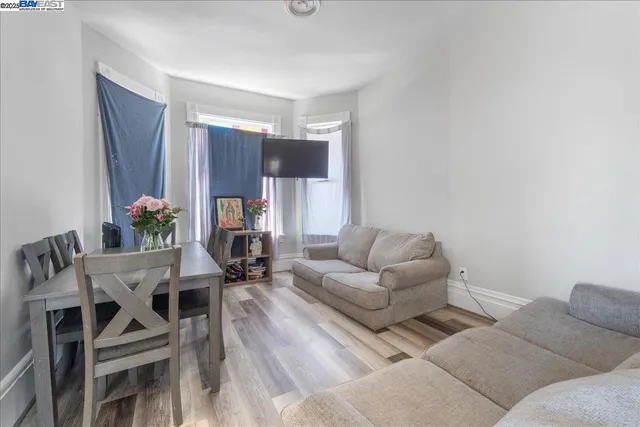 a living room with furniture a dining table and a potted plant