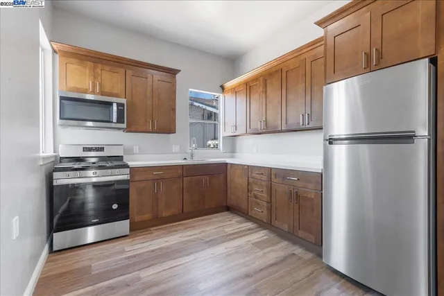 a kitchen with stainless steel appliances granite countertop a sink stove and cabinets