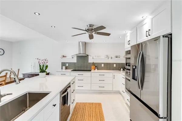 a kitchen with a sink appliances and cabinets