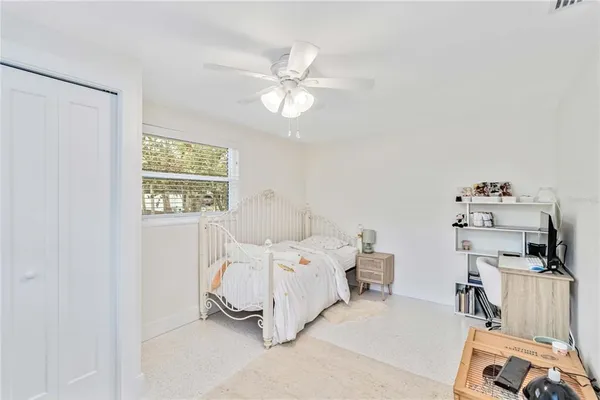 a bedroom with a bed and a window