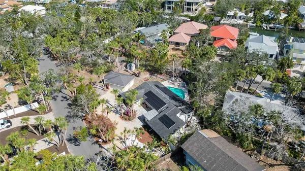 an aerial view of a house with a yard and lake view