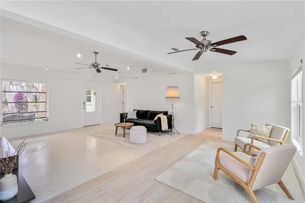 a living room with furniture and a ceiling fan