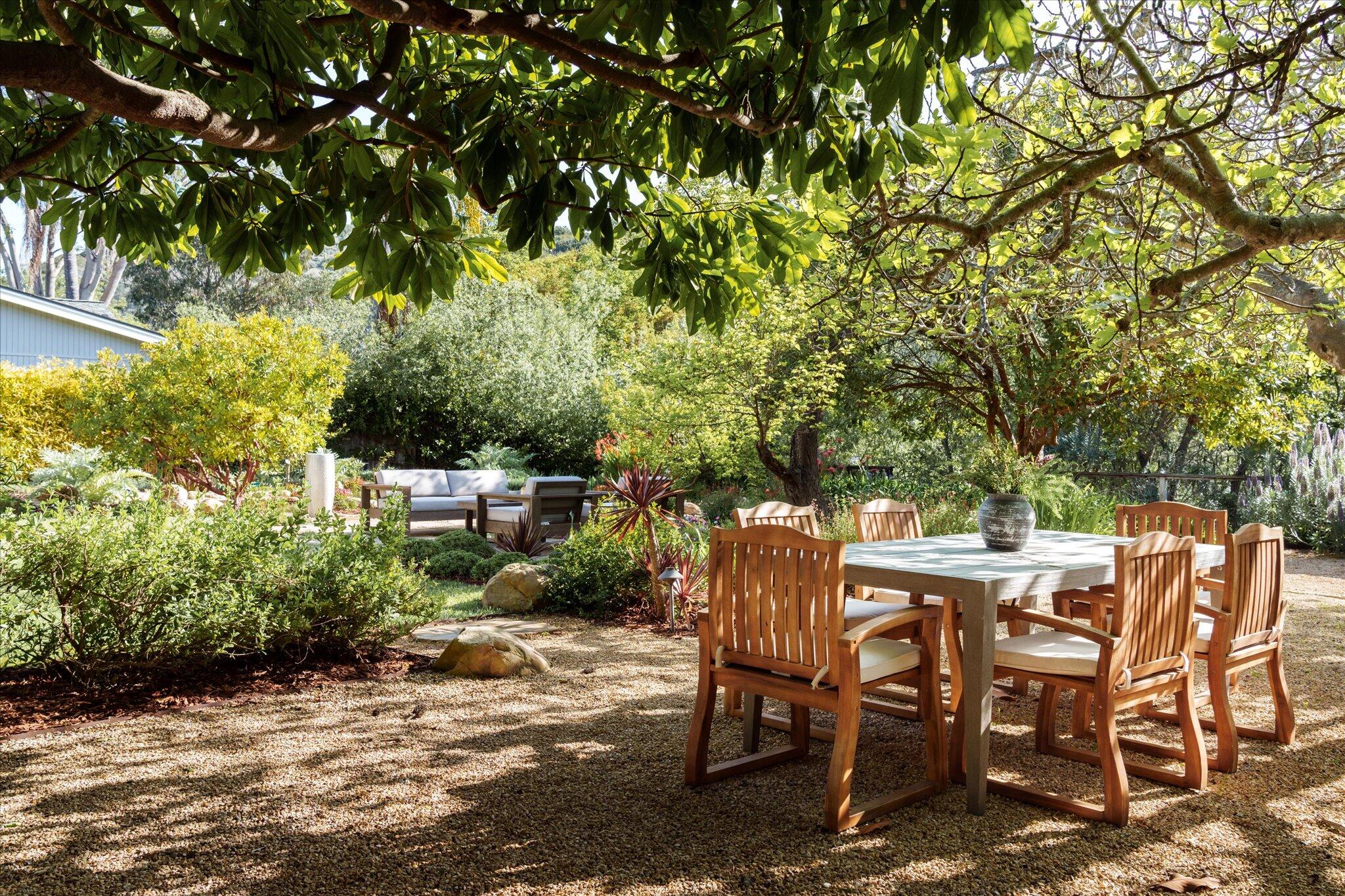 422 Alan Road Santa Barbara, CA 93109 - Photo 7 of 38 a view of a backyard with table and chairs and potted plants