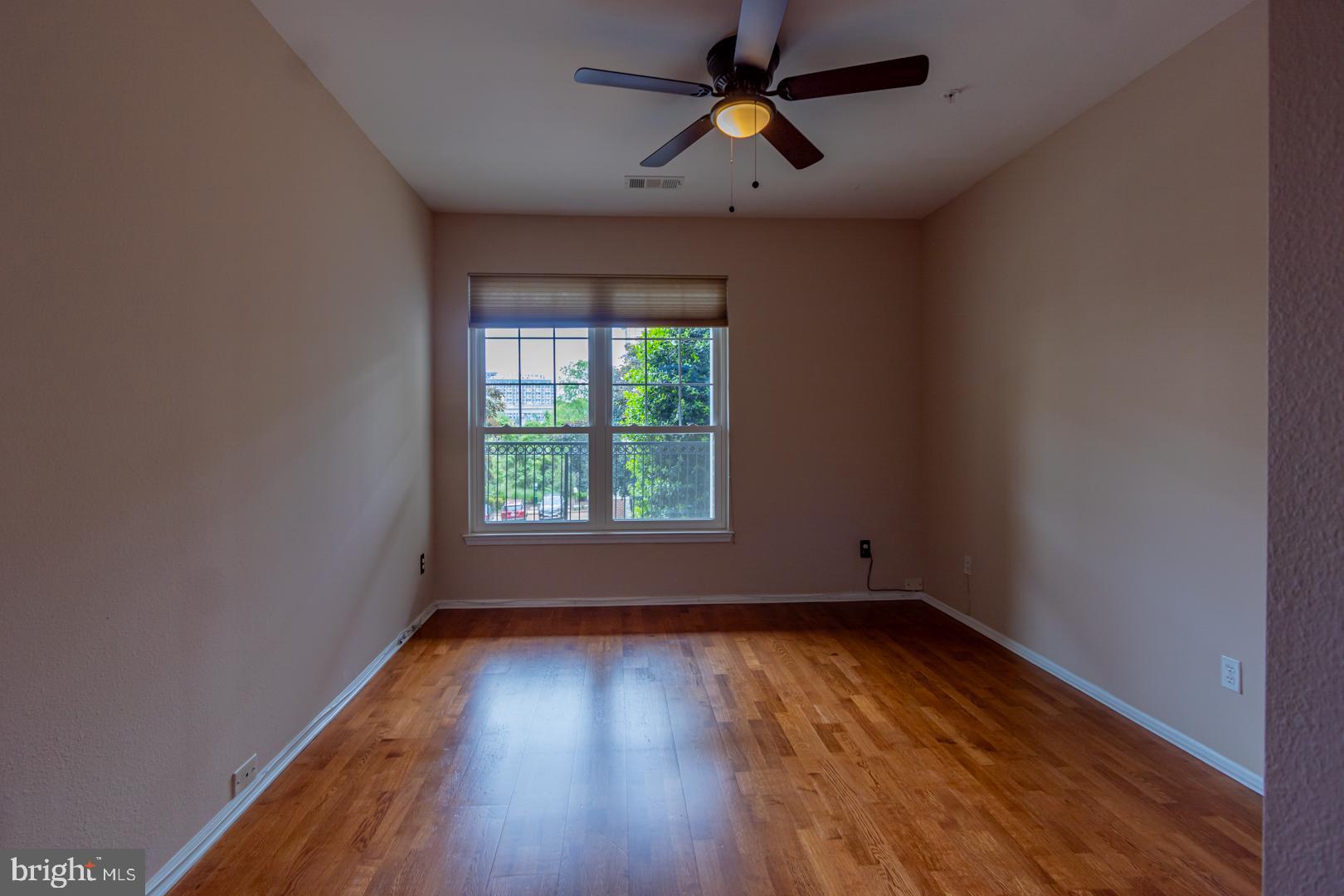 1600 Spring Gate Dr., Unit 2207 McLean, VA 22102 - Photo 23 of 32 an empty room with wooden floor and windows