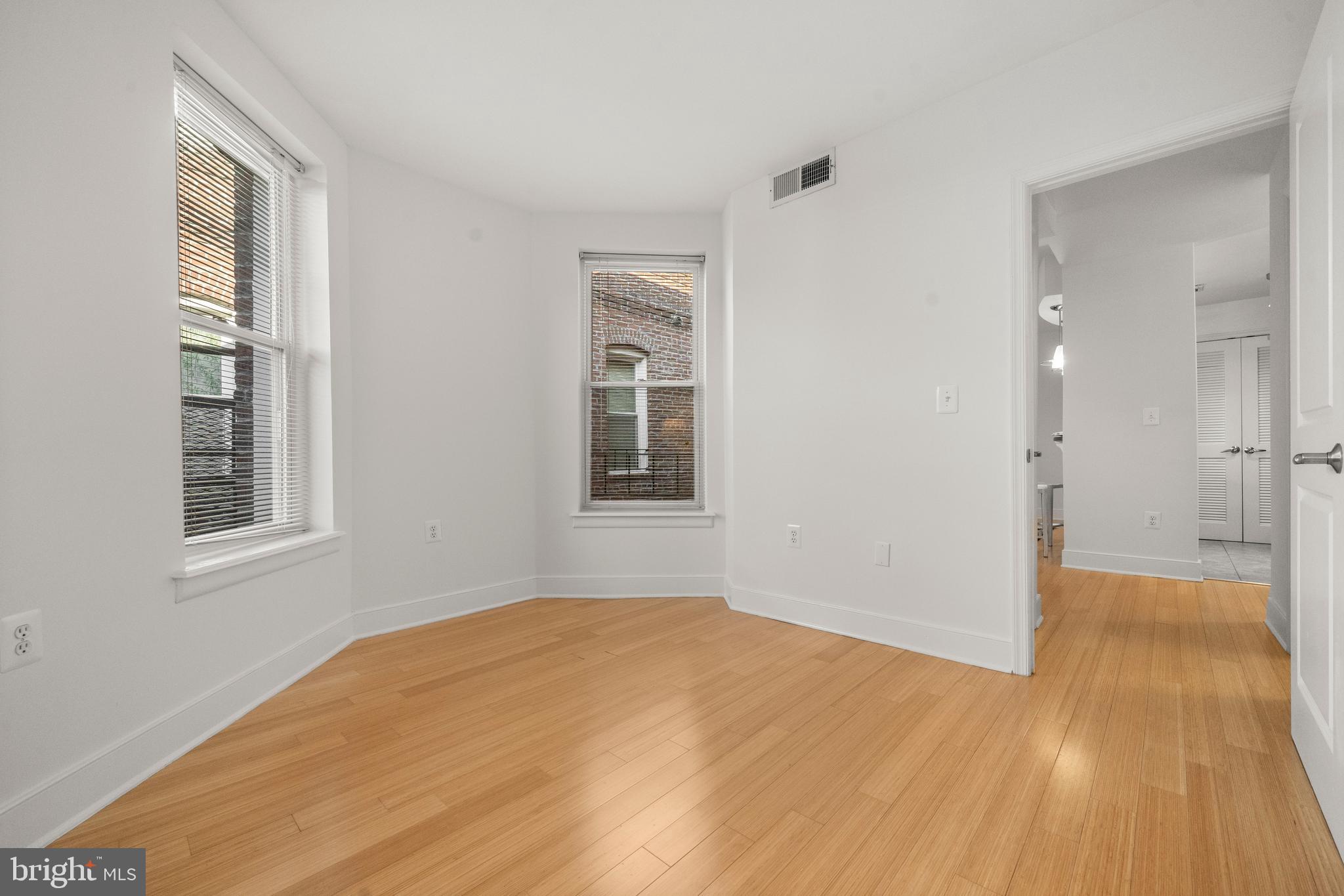 1106 Columbia Road Northwest, Unit 304 Washington, DC 20009 - Photo 15 of 24 a view of empty room with wooden floor and fan