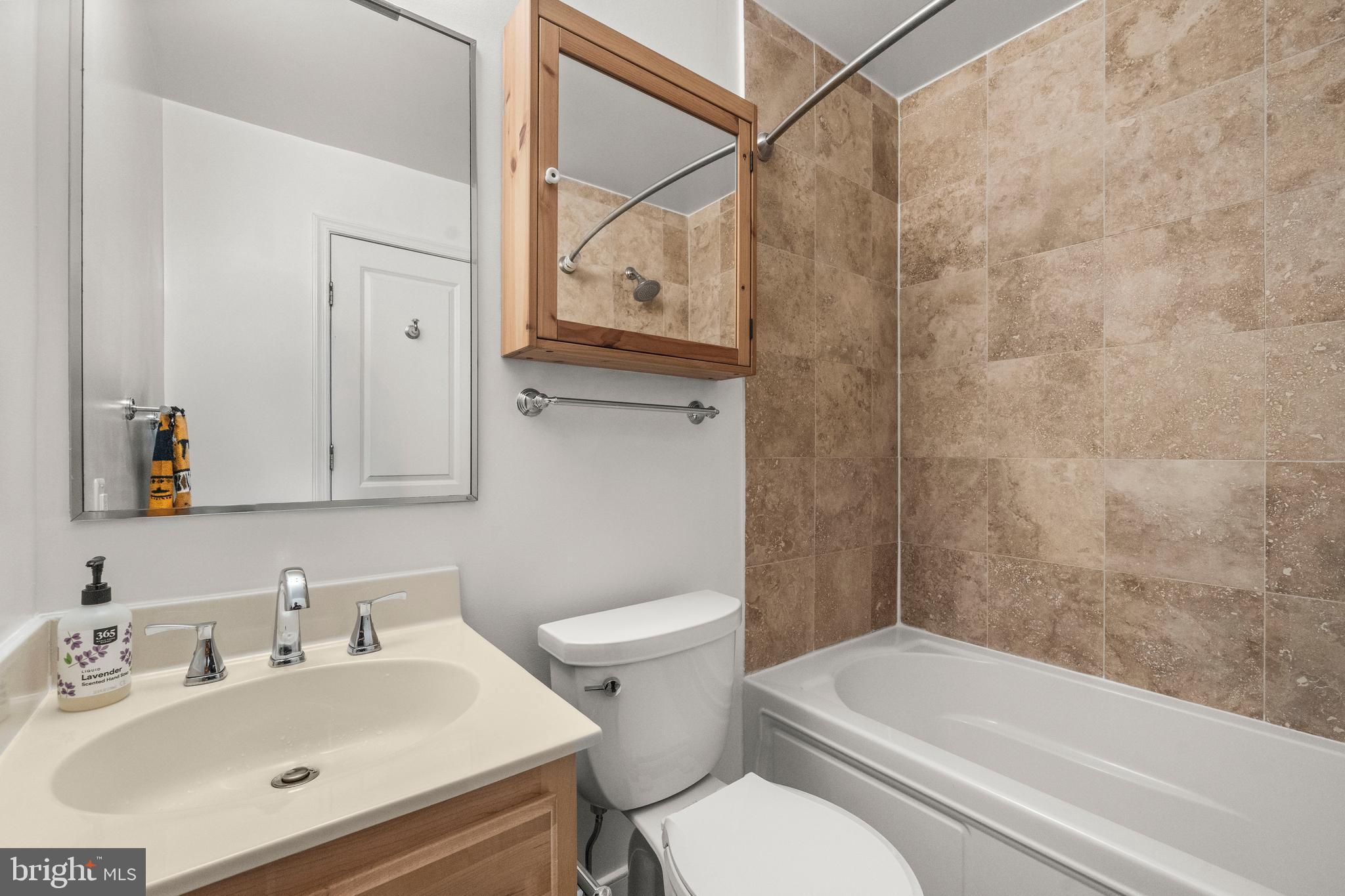 1106 Columbia Road Northwest, Unit 304 Washington, DC 20009 - Photo 20 of 24 a bathroom with a sink toilet and shower