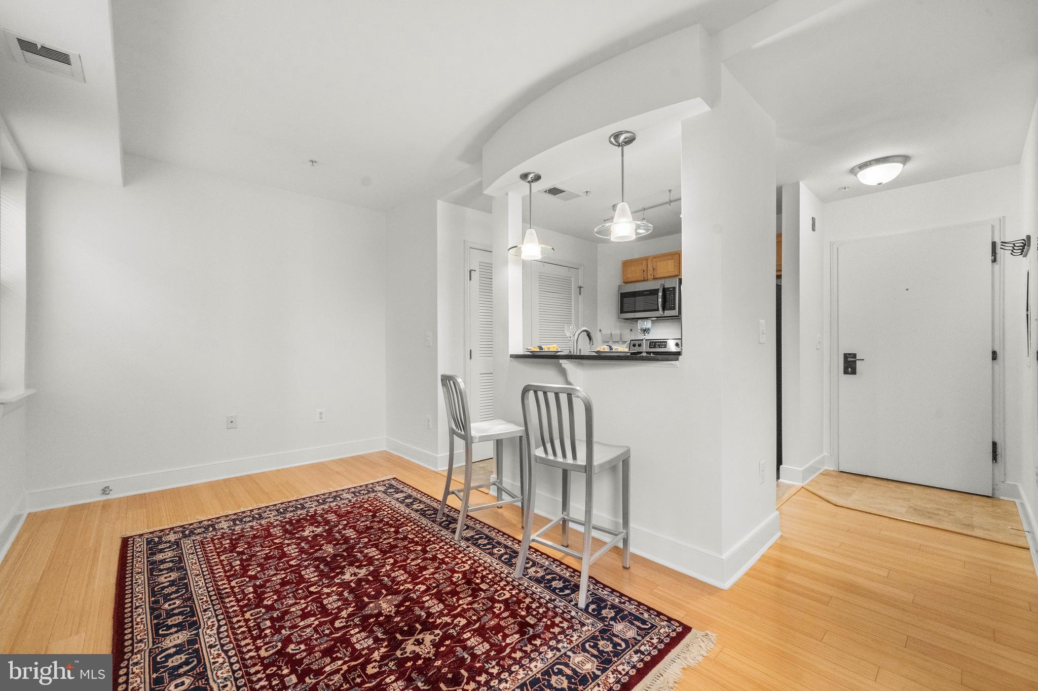 1106 Columbia Road Northwest, Unit 304 Washington, DC 20009 - Photo 2 of 24 a view of a hallway with wooden floor and a bathroom