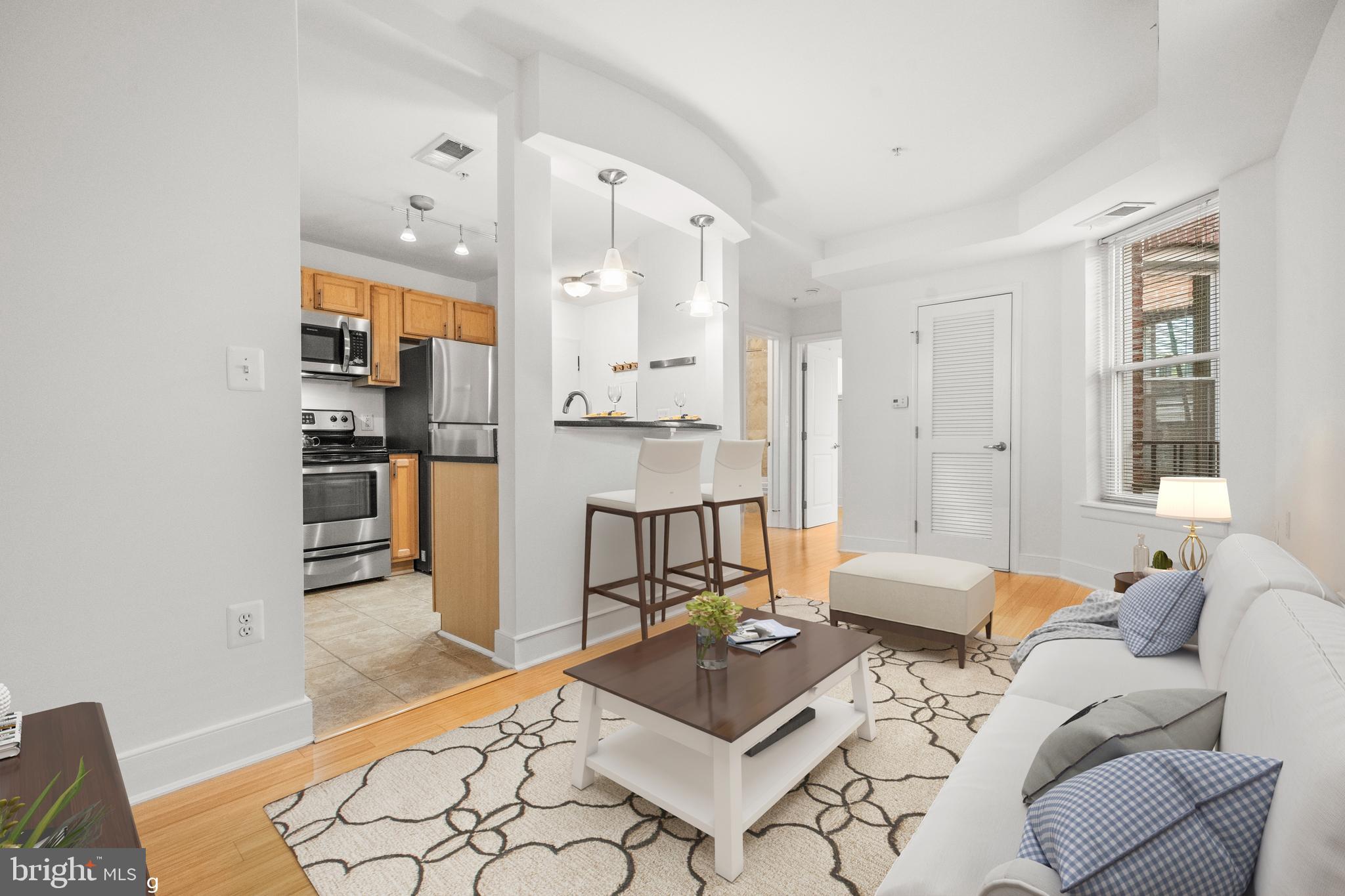 1106 Columbia Road Northwest, Unit 304 Washington, DC 20009 - Photo 5 of 24 a living room with furniture and a table