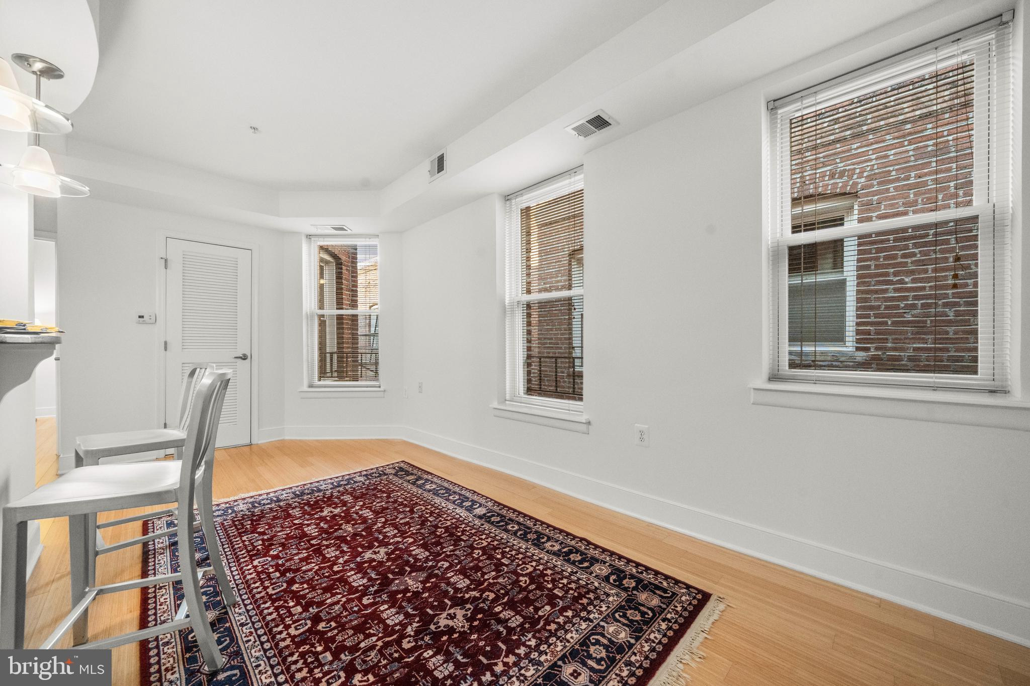 1106 Columbia Road Northwest, Unit 304 Washington, DC 20009 - Photo 7 of 24 a view of an empty room with a window