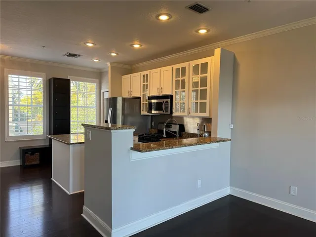 a kitchen with cabinets and window