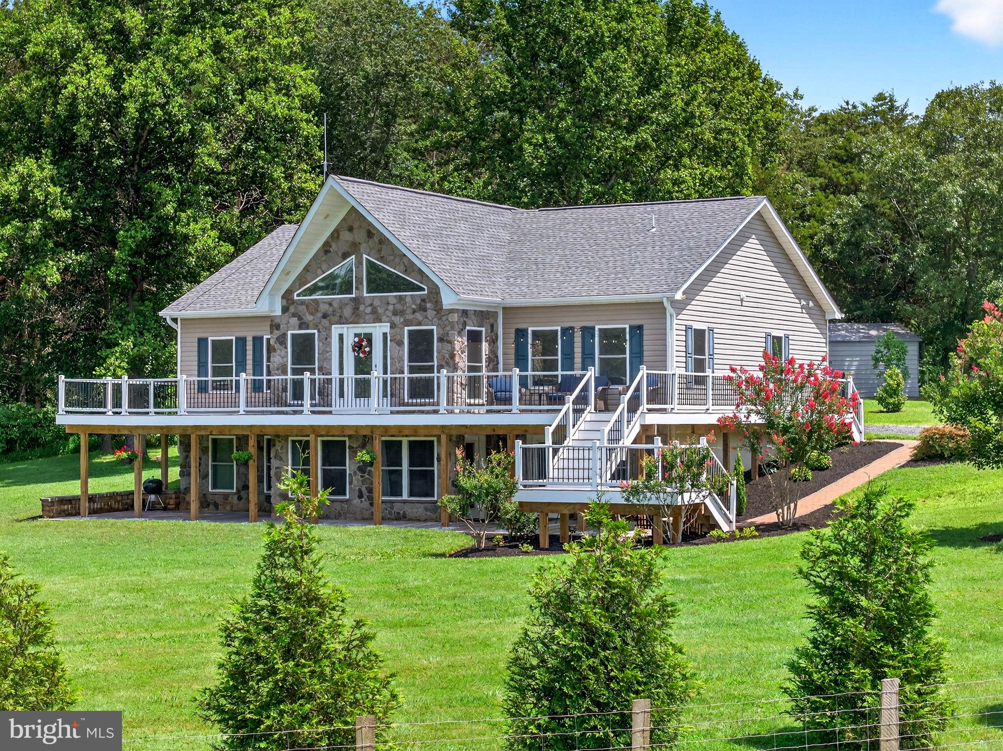 a front view of a house with a yard table and chairs