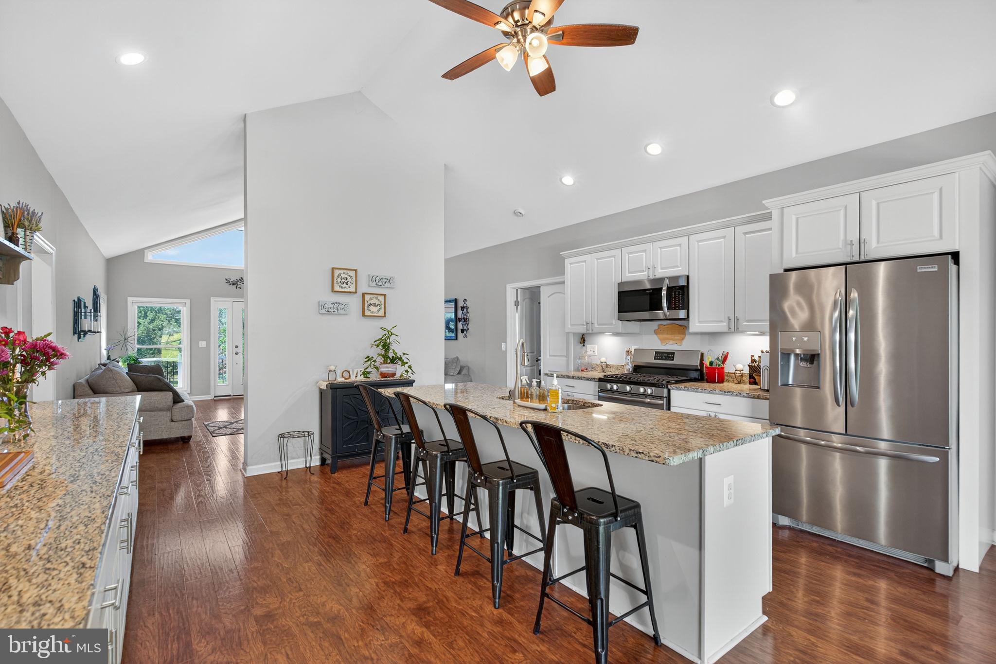 14451 Jenkins Ridge Road Culpeper, VA 22701 - Photo 14 of 78 a kitchen with stainless steel appliances a dining table chairs stove refrigerator and sink