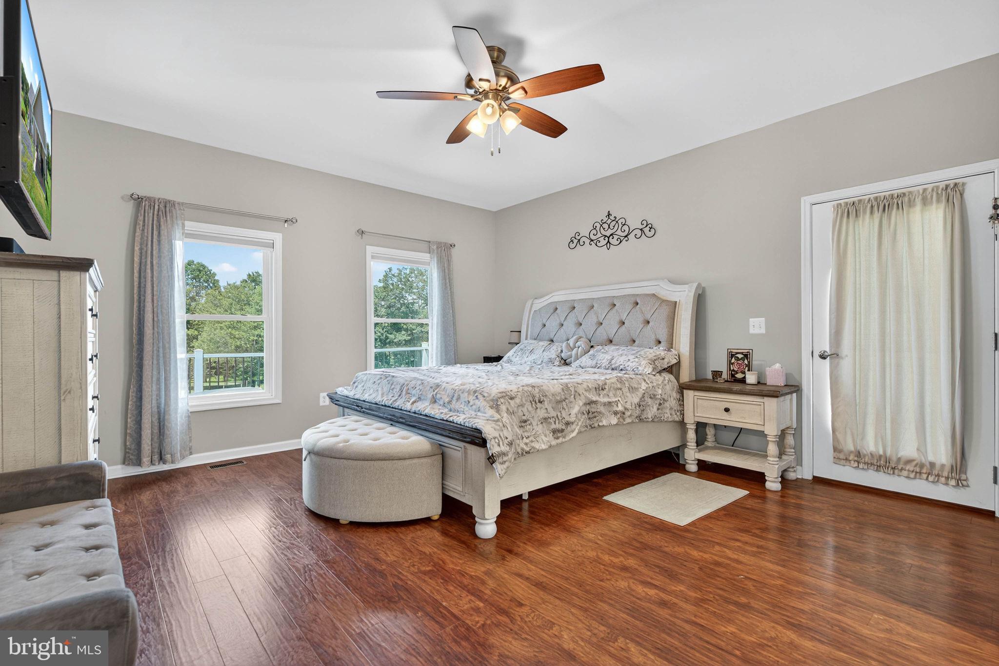 14451 Jenkins Ridge Road Culpeper, VA 22701 - Photo 19 of 78 a bedroom with a bed and large windows