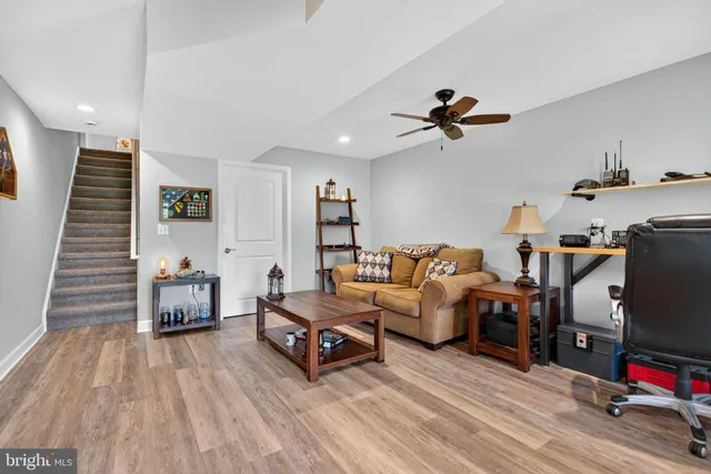 a aerial view of a house with pool and trees in the background
