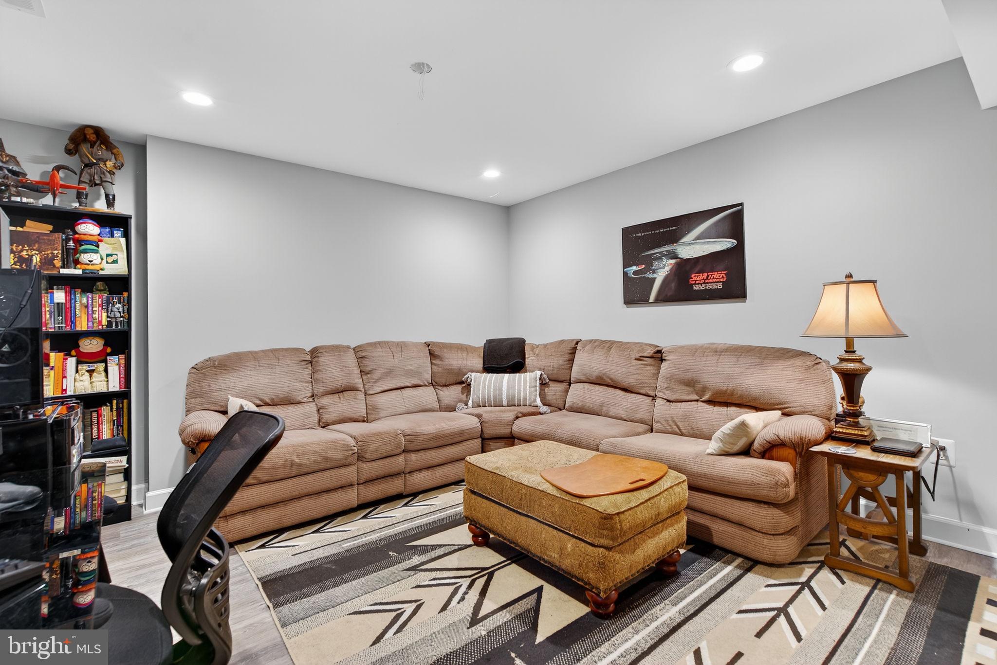 14451 Jenkins Ridge Road Culpeper, VA 22701 - Photo 45 of 78 a living room with furniture and a bookshelf with wooden floor