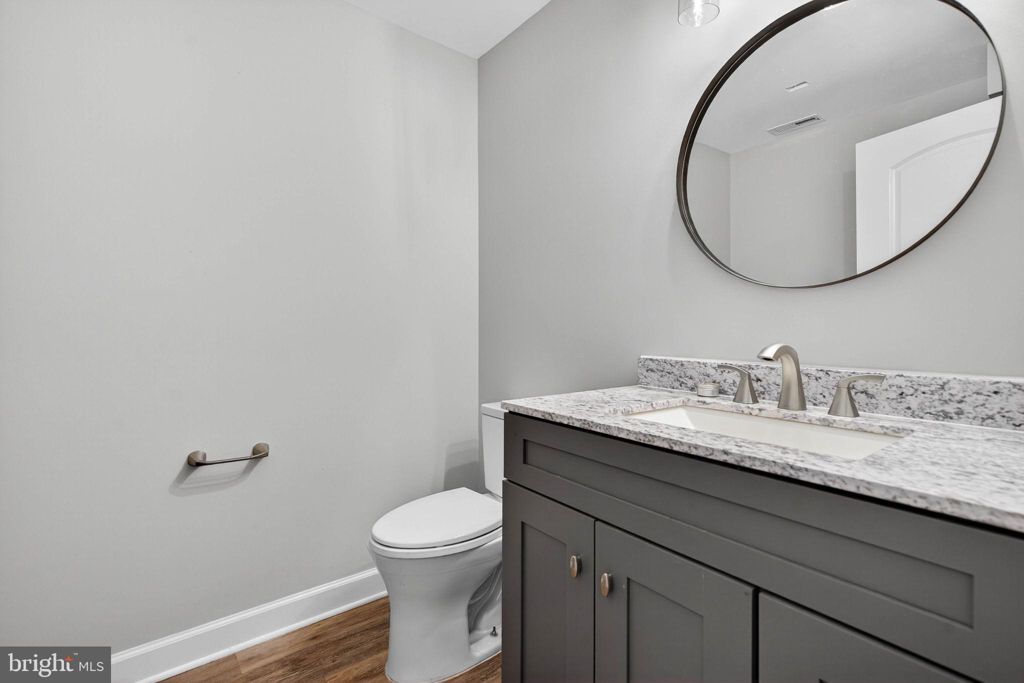 14451 Jenkins Ridge Road Culpeper, VA 22701 - Photo 47 of 78 a bathroom with a granite countertop toilet sink and mirror