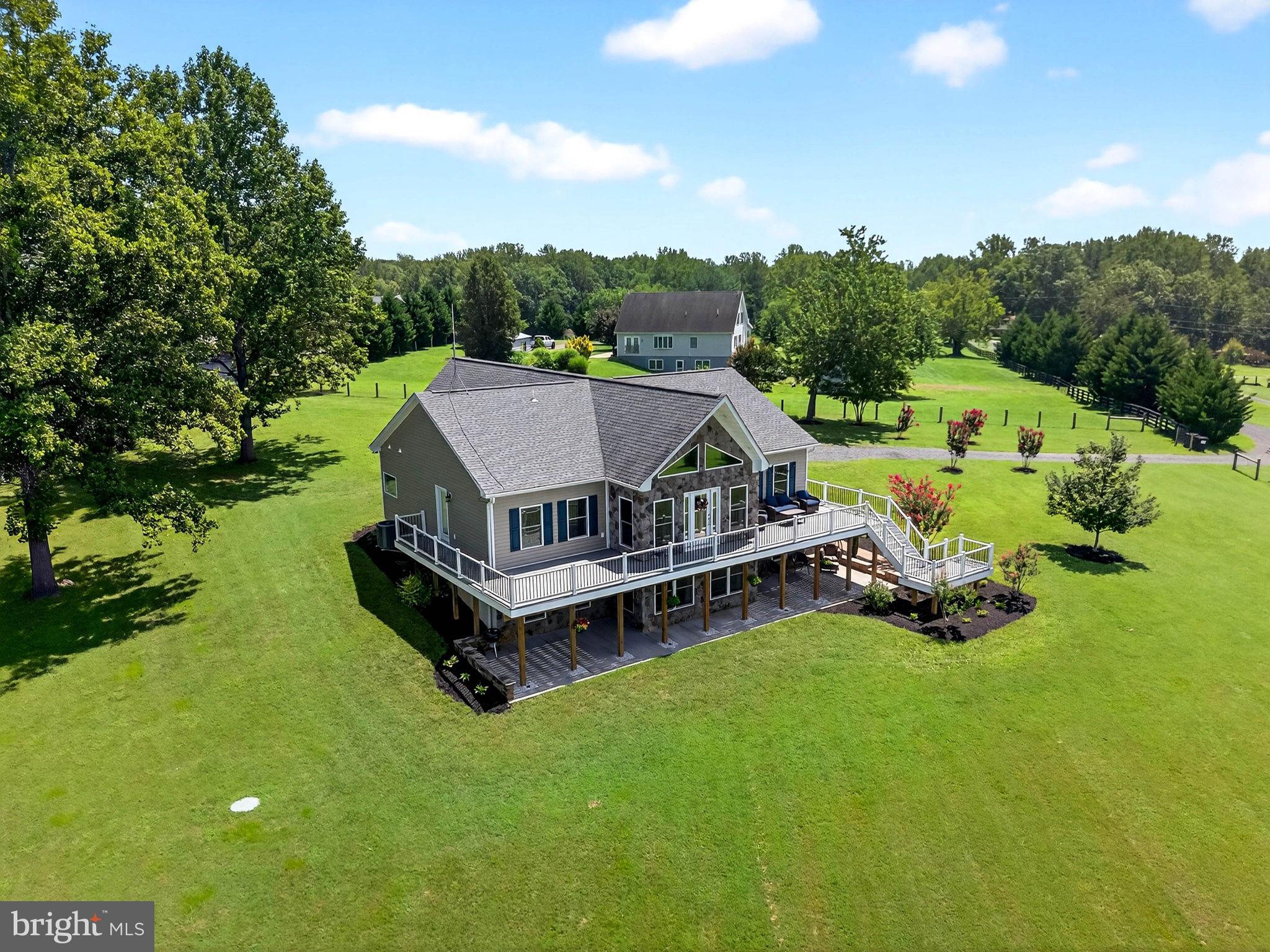 14451 Jenkins Ridge Road Culpeper, VA 22701 - Photo 64 of 78 a aerial view of a house with pool and trees in the background