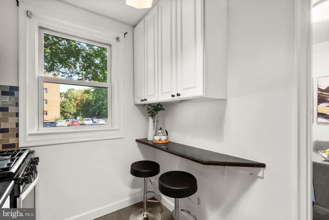 a kitchen with a window a sink and a stove