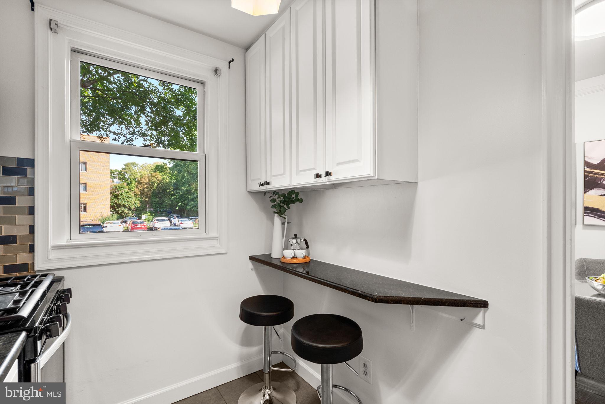 4820 Chevy Chase Drive, Unit 101 Chevy Chase, MD 20815 - Photo 13 of 30 a kitchen with a window a sink and a stove
