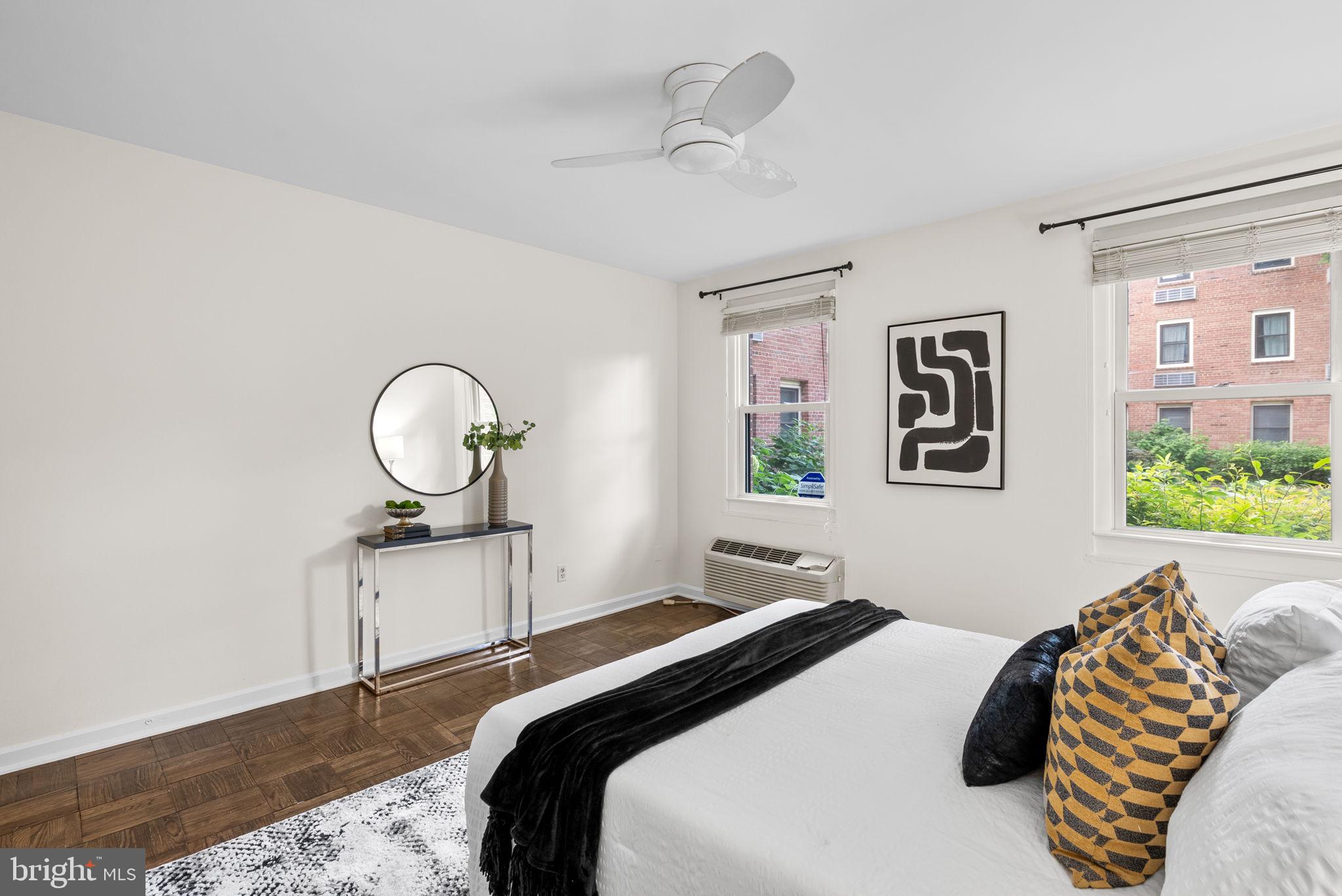 4820 Chevy Chase Drive, Unit 101 Chevy Chase, MD 20815 - Photo 15 of 30 a bedroom with a bed and wooden floor