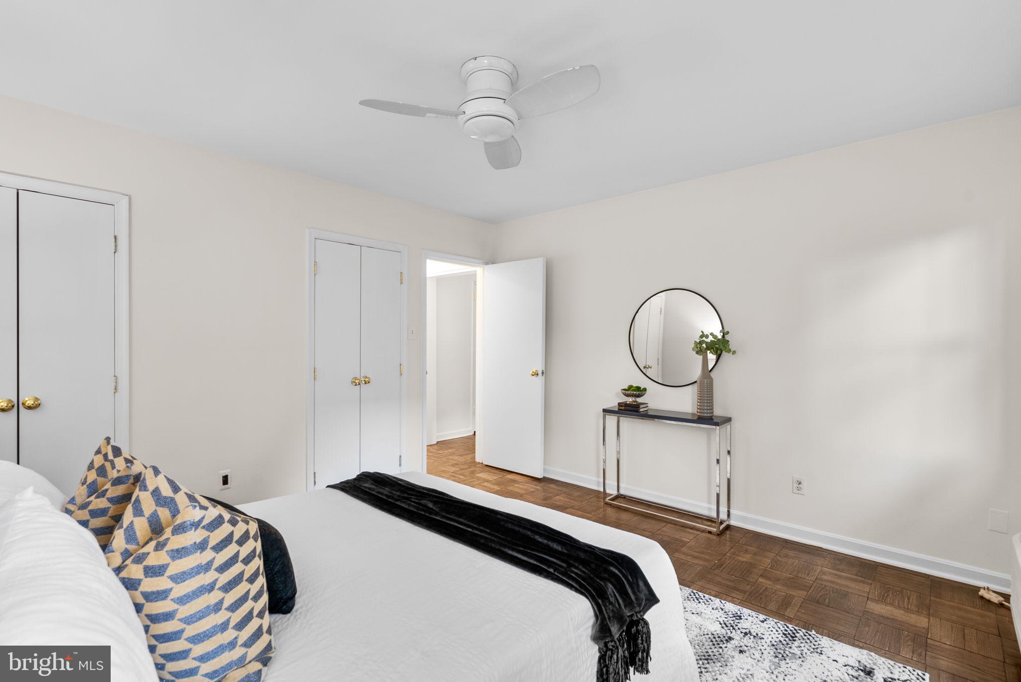 4820 Chevy Chase Drive, Unit 101 Chevy Chase, MD 20815 - Photo 16 of 30 a bedroom with a bed and a chandelier