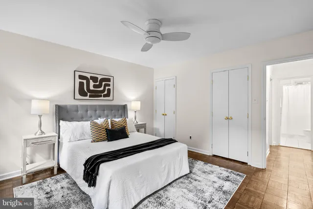 a bedroom with a large bed and a chandelier