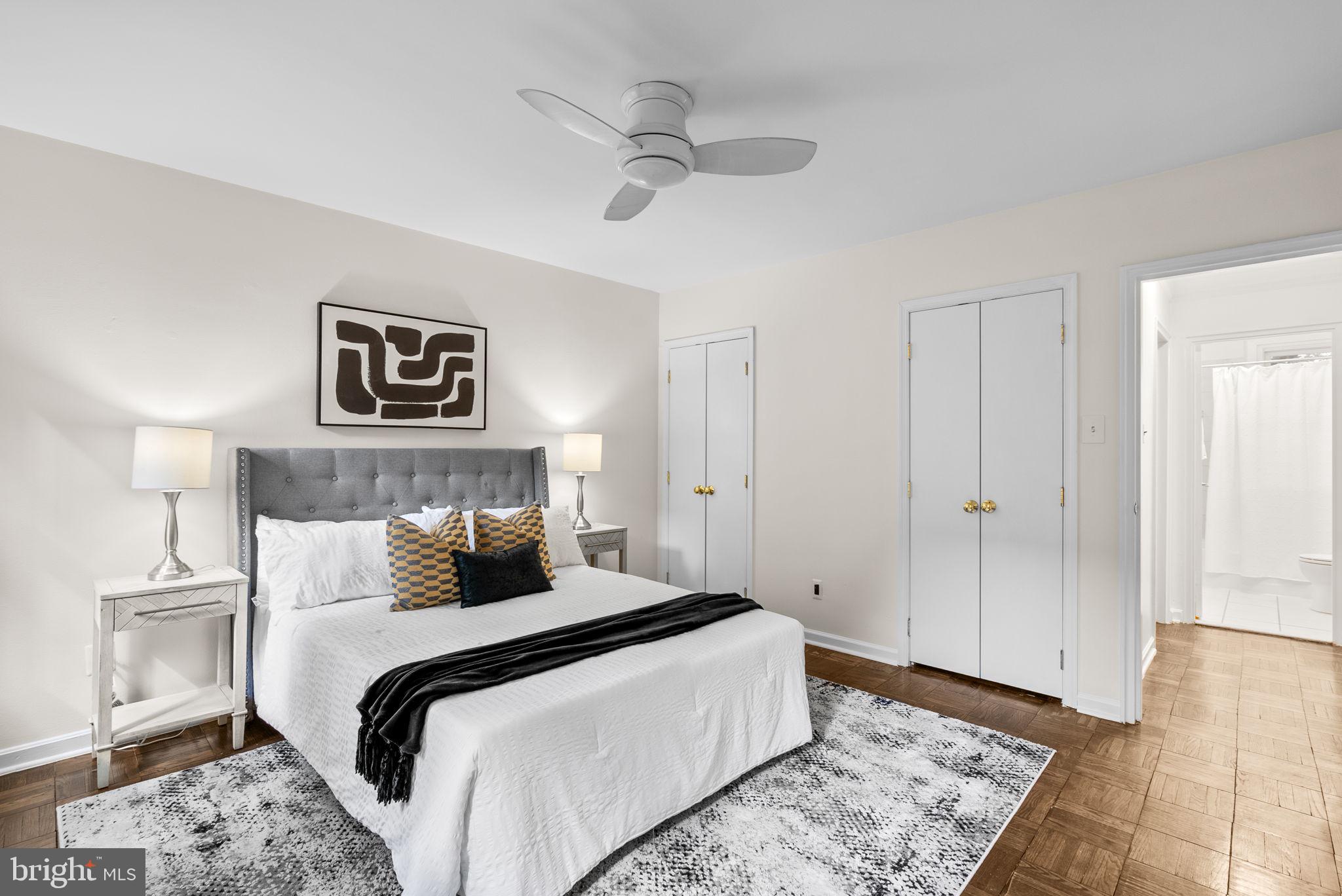 4820 Chevy Chase Drive, Unit 101 Chevy Chase, MD 20815 - Photo 18 of 30 a bedroom with a large bed and a chandelier