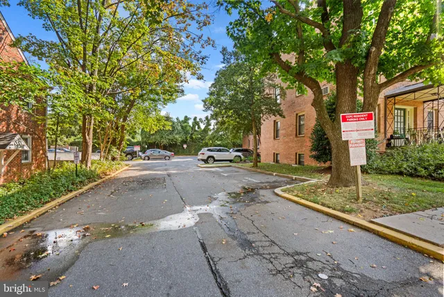 a street sign on a sidewalk next to a road