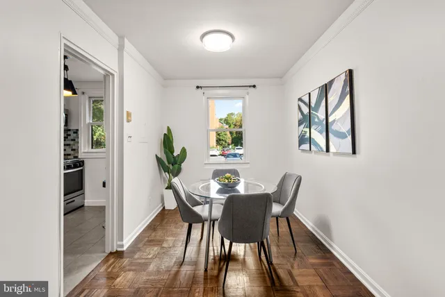 a view of a dining room with furniture and a potted plant