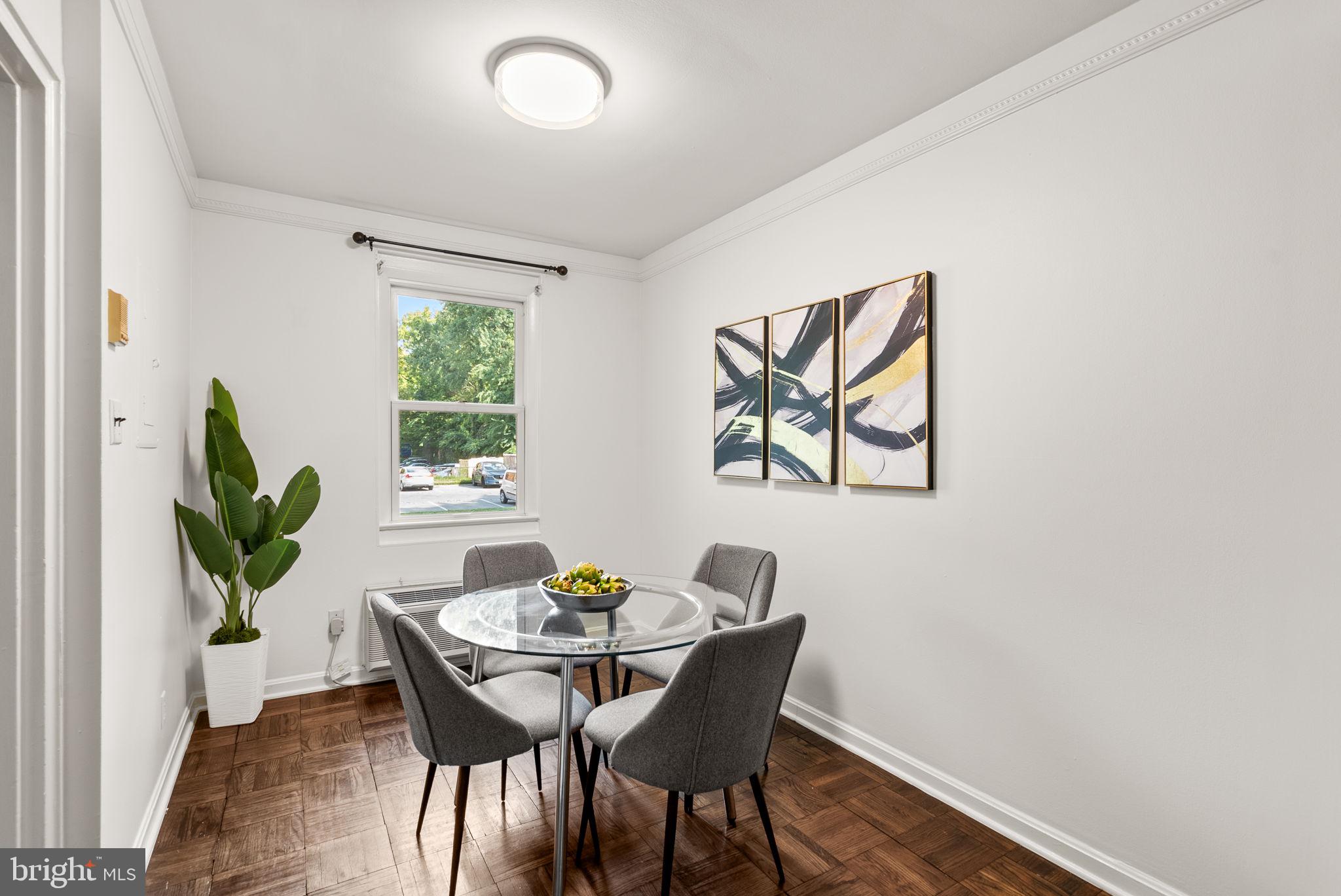 4820 Chevy Chase Drive, Unit 101 Chevy Chase, MD 20815 - Photo 6 of 30 a view of a dining room with furniture and window