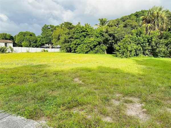 a view of yard with swimming pool and green space