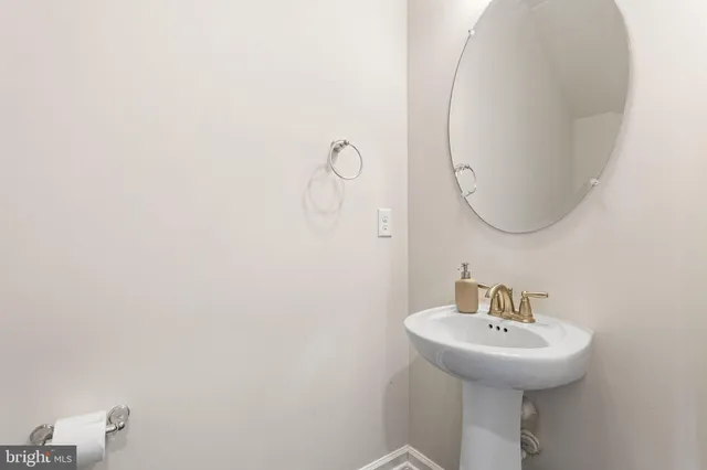 a bathroom with a sink and mirror