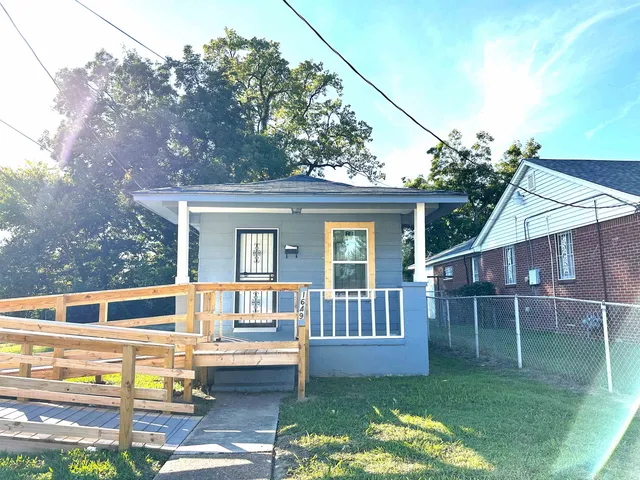 a view of house with a yard from a balcony