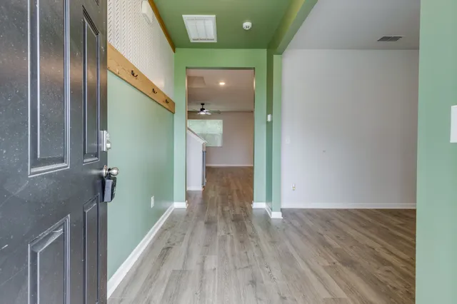 a view of a hallway with wooden floor