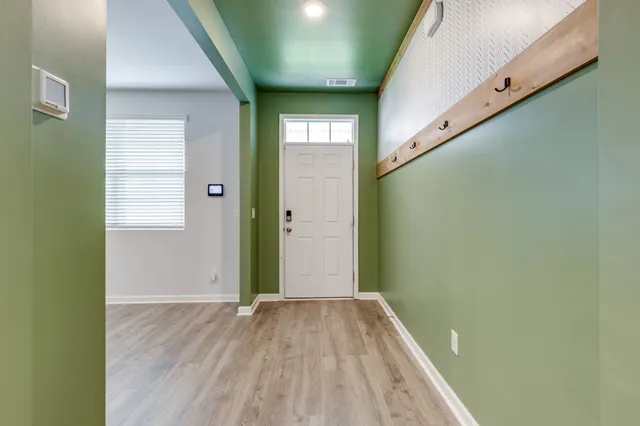 a view of a hallway with wooden floor