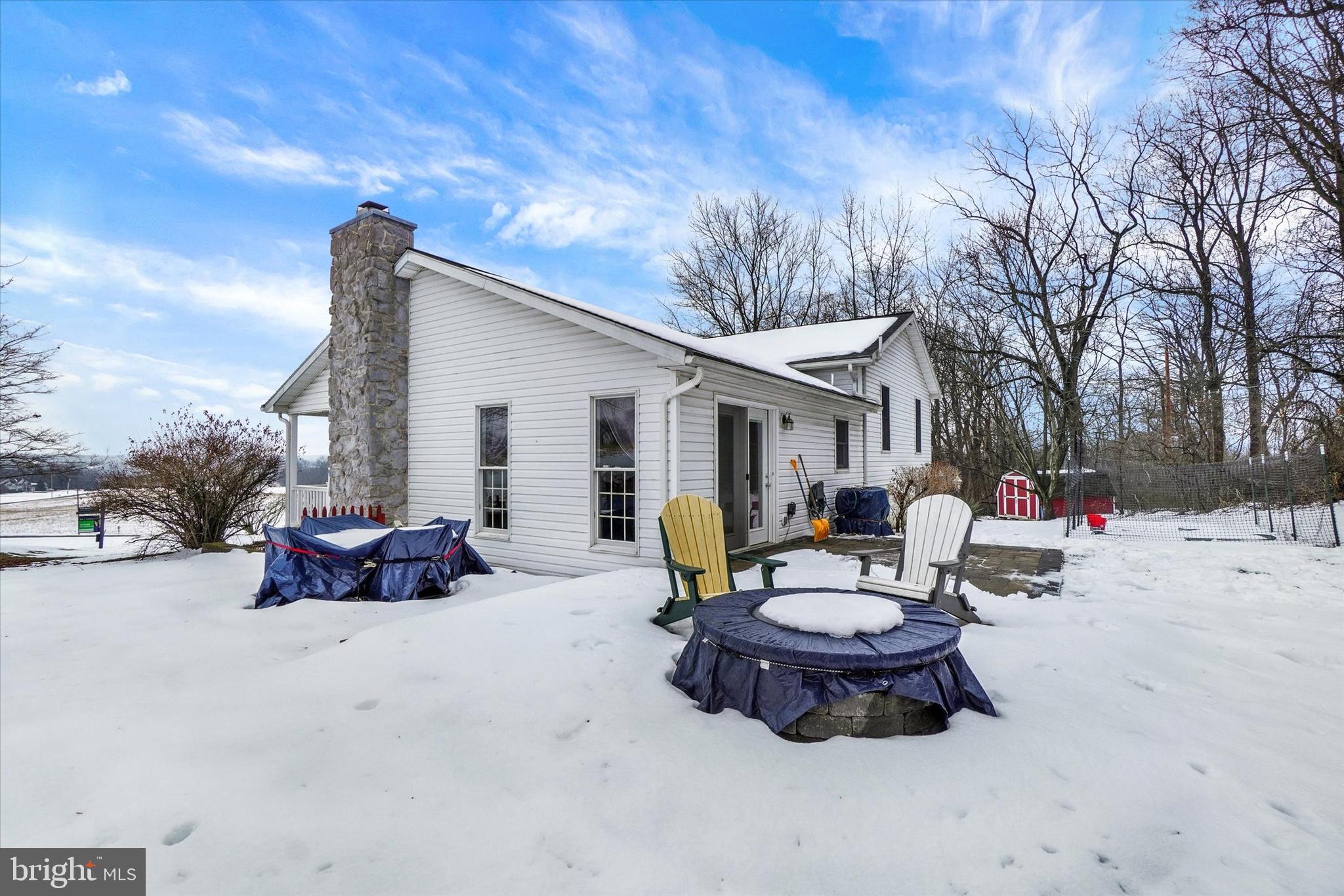 194 Willis Road Etters, PA 17319 - Photo 23 of 31 a view of a patio with a table and chairs and a fire pit