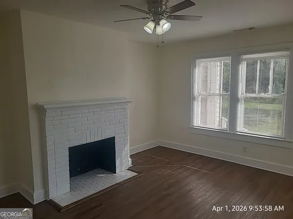 a view of a livingroom with a fireplace and window
