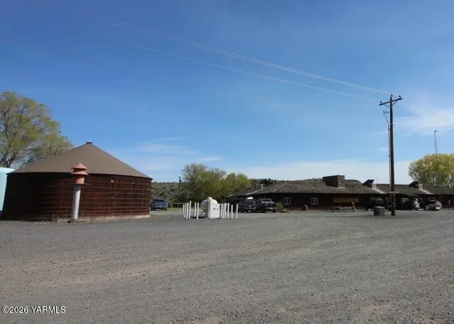 a view of a house with a yard and sitting area