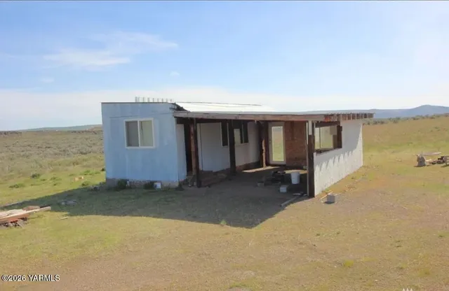 a view of a house with backyard and ocean view