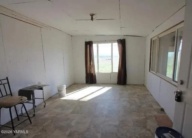 a view of a room with furniture and windows