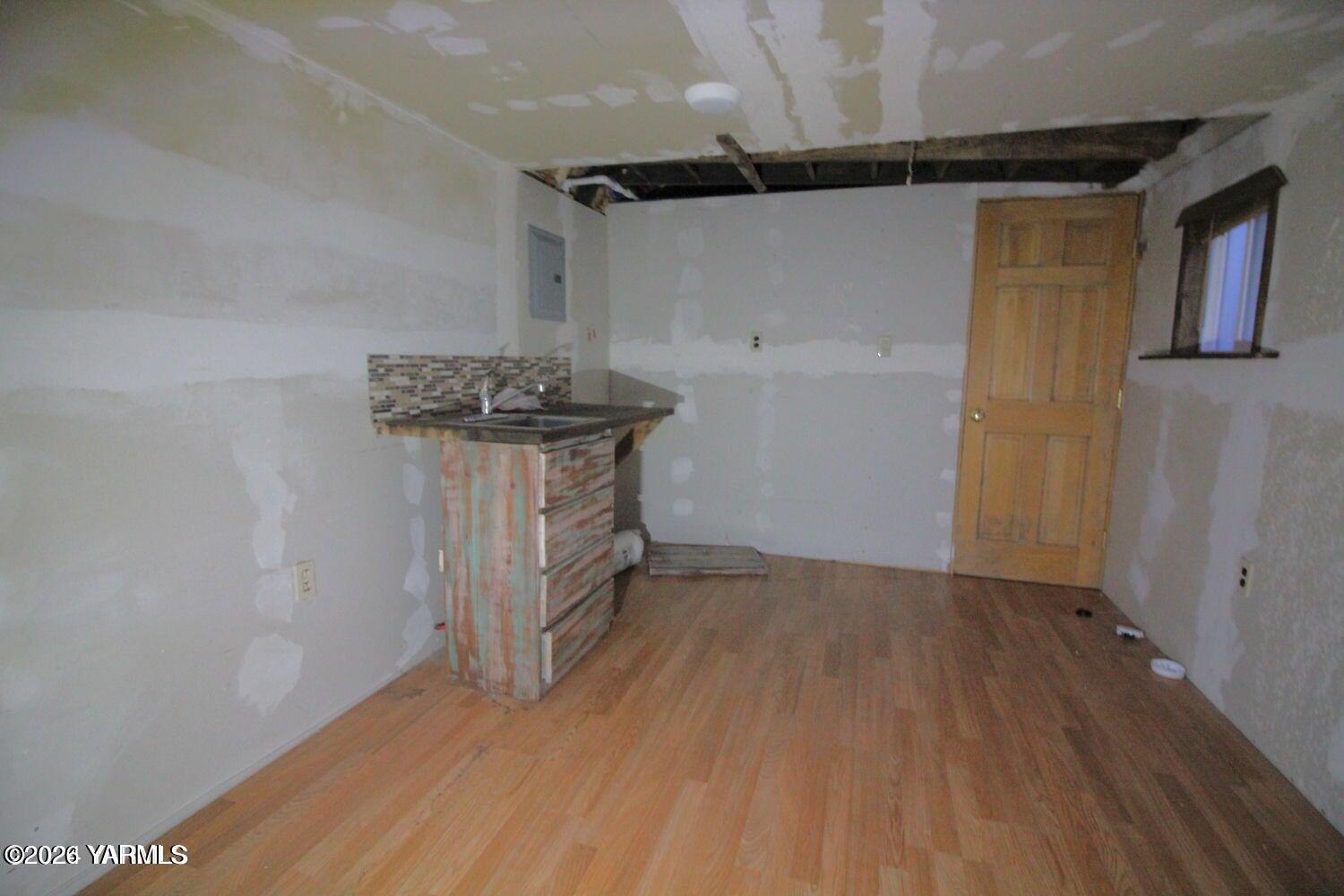 102 Hackney Court Ephrata, WA 98823 - Photo 5 of 16 a view of a room with wooden floor a sink and a window