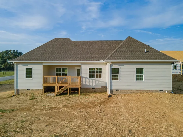 a balcony with wooden floor and fence