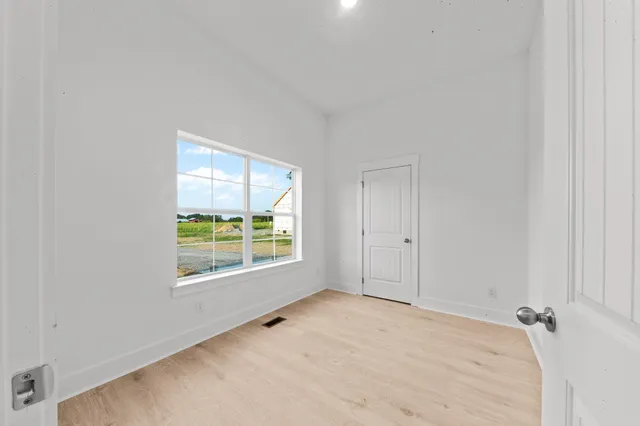 a kitchen with kitchen island granite countertop a sink a stove and cabinets