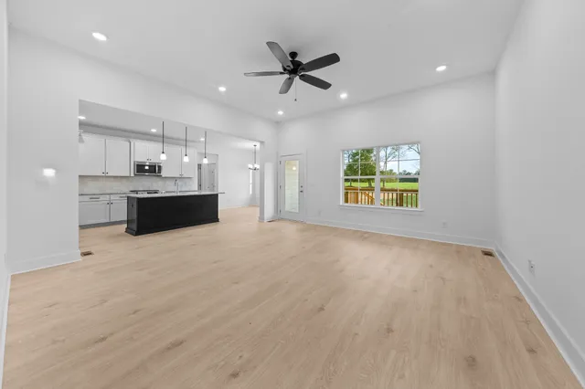 a view of wooden floor chandelier and window in a room