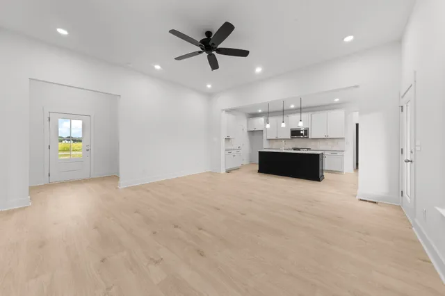a kitchen with granite countertop a sink a stove and cabinets