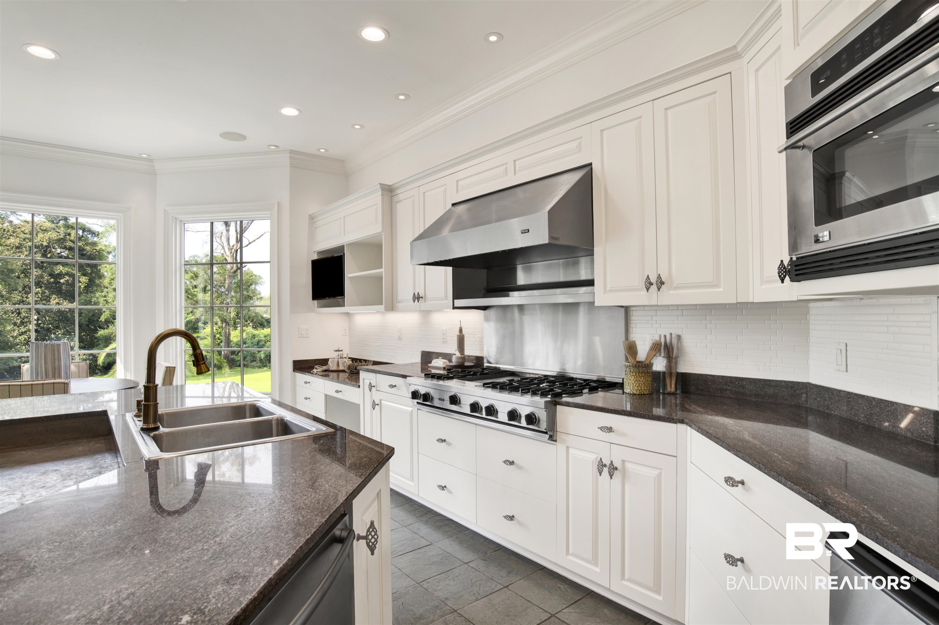 3816 Austill Lane Mobile, AL 36608 - Photo 24 of 80 Kitchen featuring tasteful backsplash, crown molding, exhaust hood, white cabinets, and recessed lighting